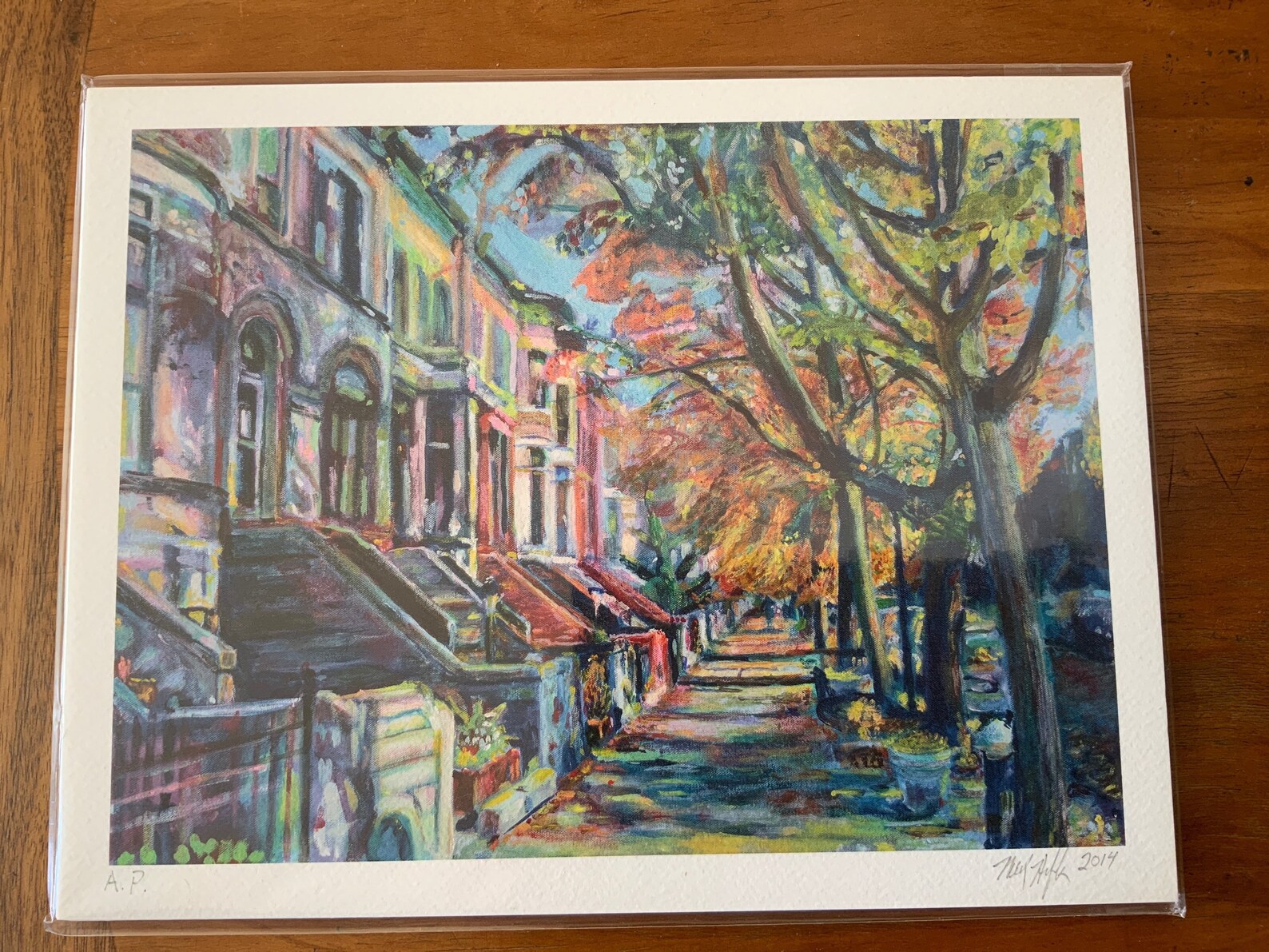 Artist proof of Midwood Street Brownstones giclee print lying face up on wooden table