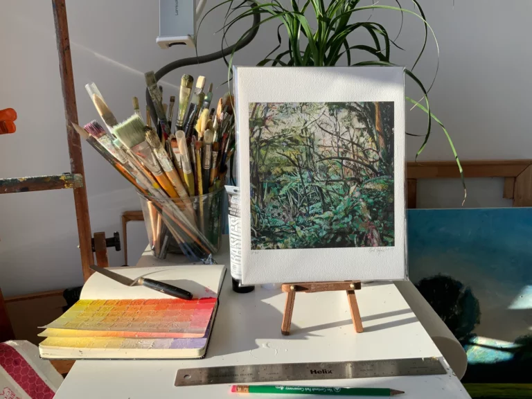 8.5" x 11" giclee print of "Grove of Trees in Devon, England" on artist's table with studio background