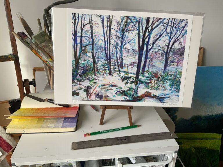 Limited edition gicleé print of winter scene by Noel Hefele on art table