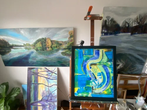 Blue and green abstract painting on easel in studio