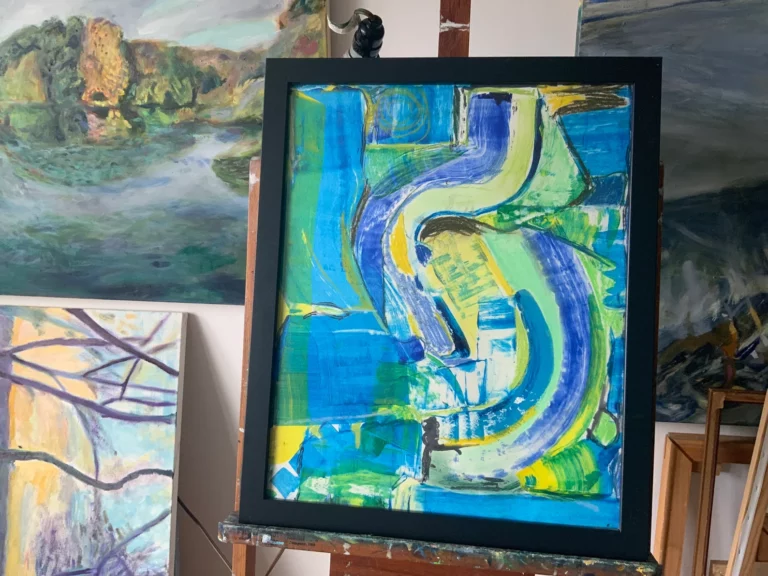 Close-up of blue and green abstract painting on easel