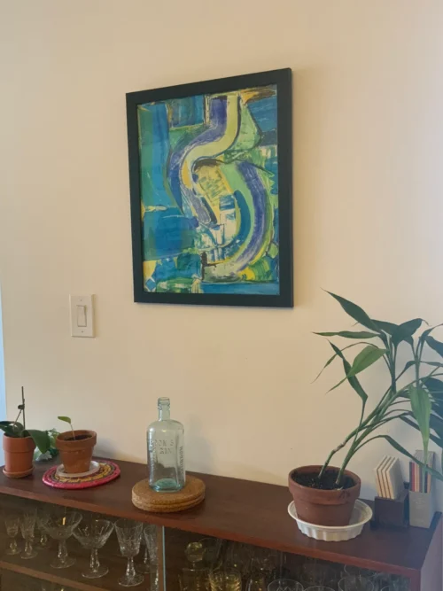 Blue and green abstract painting hanging on wall