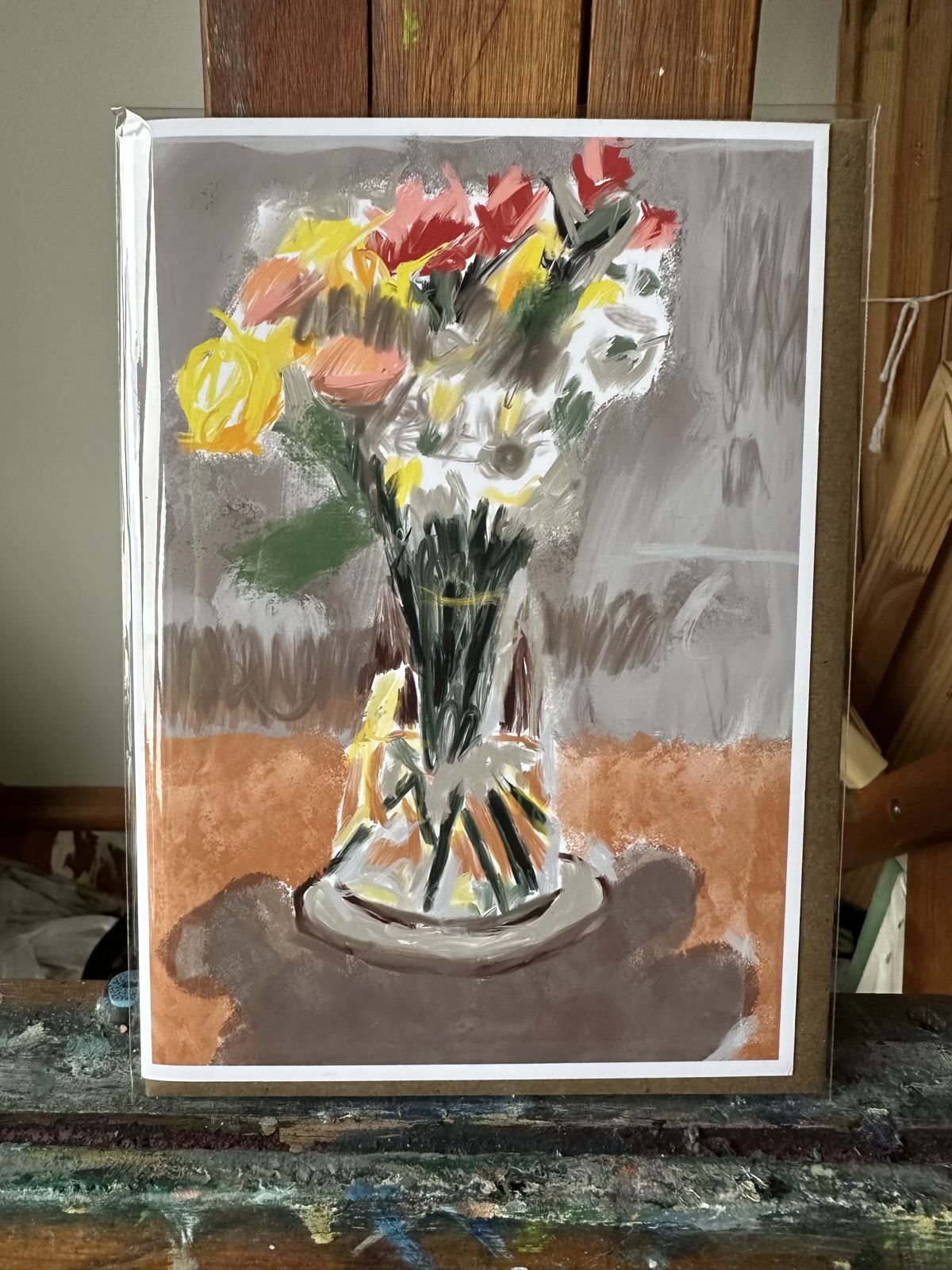 Greeting card featuring a Procreate digital artwork by Noel Hefele, presenting a bouquet of red, yellow, and peach flowers in a clear vase, set against a muted backdrop.