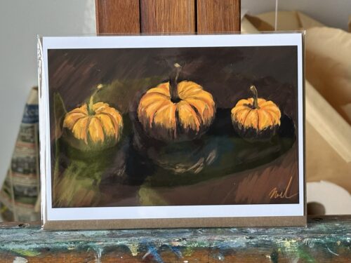 Greeting card featuring a Procreate digital artwork by Noel Hefele, illustrating three vivid pumpkins with detailed brush strokes, set against a dark, textured backdrop.