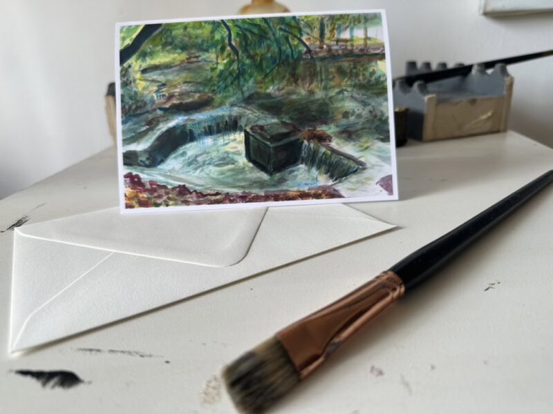 "Broadway Drain" greeting card displayed in a lifestyle setting