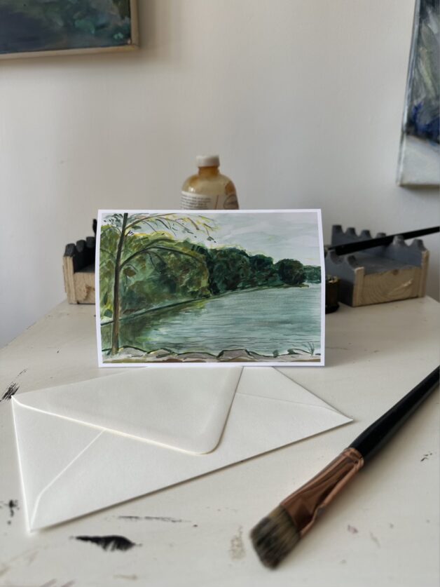 "Hester and Piero's Mill Pond" greeting card displayed in a lifestyle setting